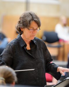 Marty Knieriem conducting with a blurred background