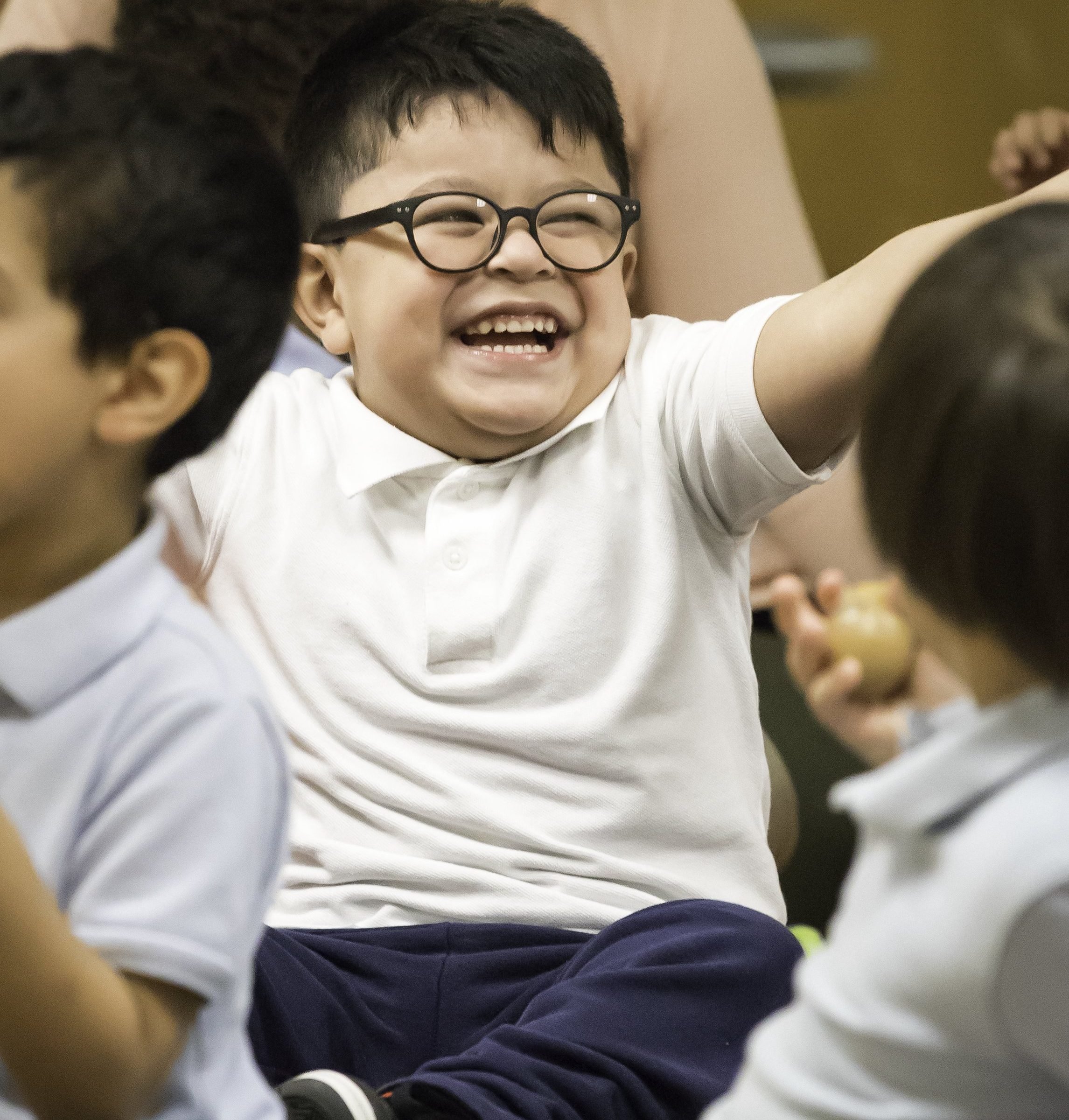 close up of AMP student sitting and smiling in an AMP music class