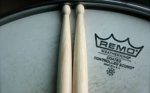 close up of a pair of drumsticks on top of a drum head