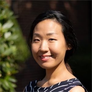 Headshot of Olivia Noh, smiling and outdoors, showing from the shoulders and above