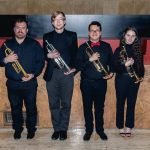 The trumpet section of YWES posing after their winter concert in Robyn Newhouse Hall