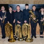 The brass section of YWES posing after their winter concert in Robyn Newhouse Hall