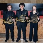 The french horn section of YWES posing after their winter concert in Robyn Newhouse Hall