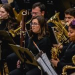 A close up of a tuba, bassoon, trumpet and saxophone players in YWES performing in their winter concert