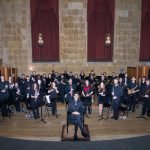 YWES on stage in Robyn Newhouse Hall for a concert, standing with instruments