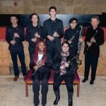 The clarinet section of YWES posing with Mary Ellen Miller and their clarinets after a concert in Robyn Newhouse Hall