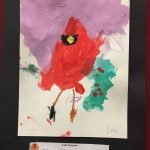 Prelude preschool art piece, a painting of a red cardinal with a black paper border