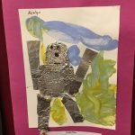 Prelude preschool art piece, a robot made of tin foil with painting in the background and a magenta paper border