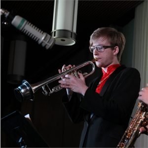 Justin Esiason playing trumpet in a recording studio