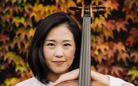 Woman leaning on bass