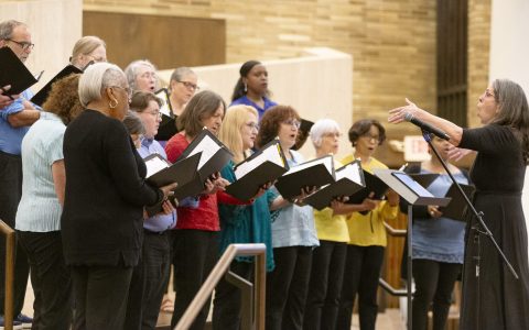 a group of adults singing in a chorus